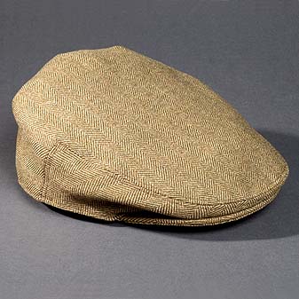 Hergestellt in Handarbeit aus Wolltweed in Fischgrätmuster.